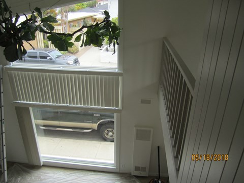 A car is parked in a driveway outside a house.