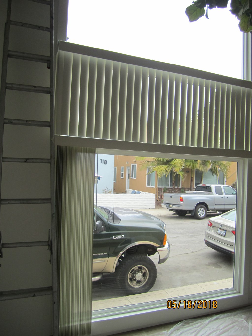 A car is parked in a driveway in front of a house.
