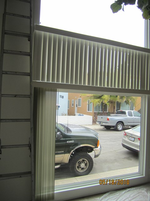 A car is parked in a driveway in front of a house.