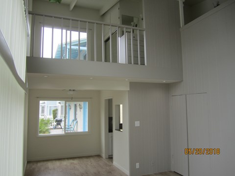 A room with a window and a balcony is empty and waiting to be furnished.