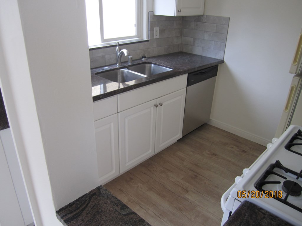 A kitchen with a sink and a window.
