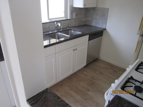 A kitchen with a sink and a window.