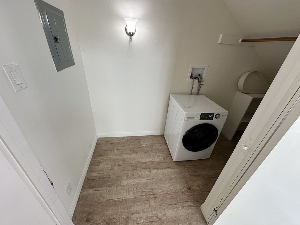 A small laundry room with a washer and dryer.