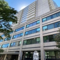 a tall building with a tree in front of it