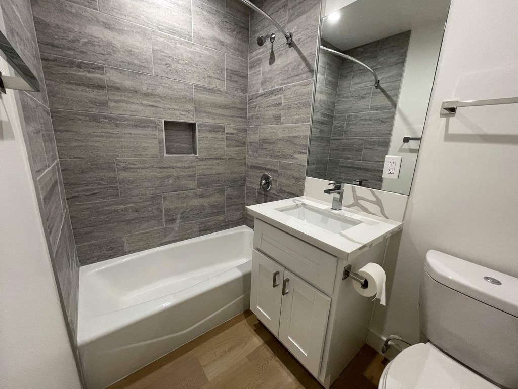 a bathroom with a sink toilet and a bath tub