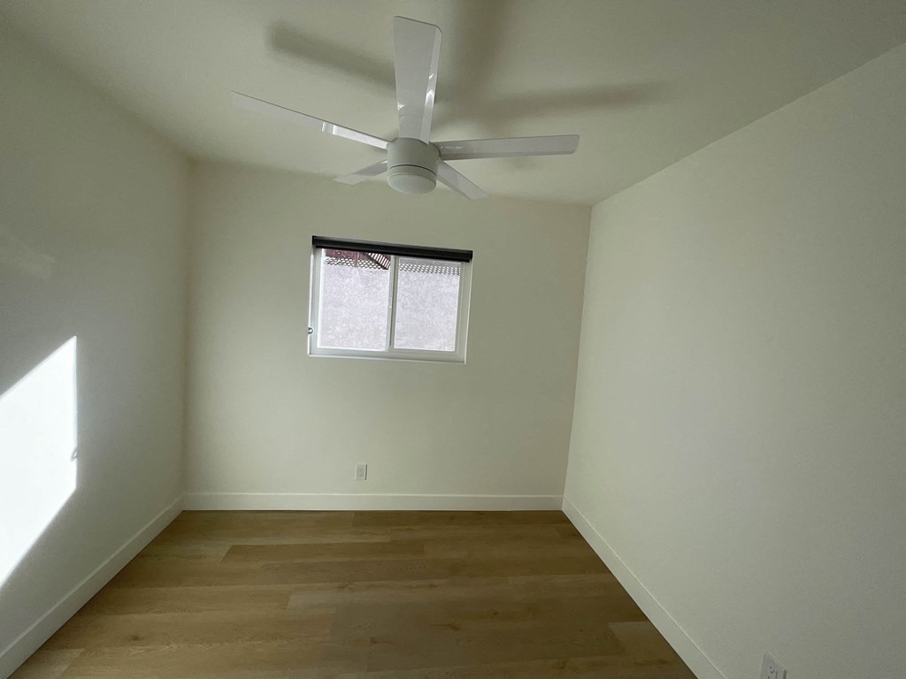 a room with a ceiling fan and a window