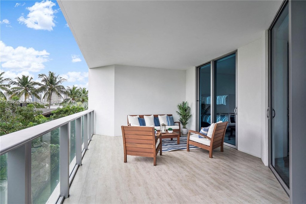 a patio with a table and chairs on a balcony