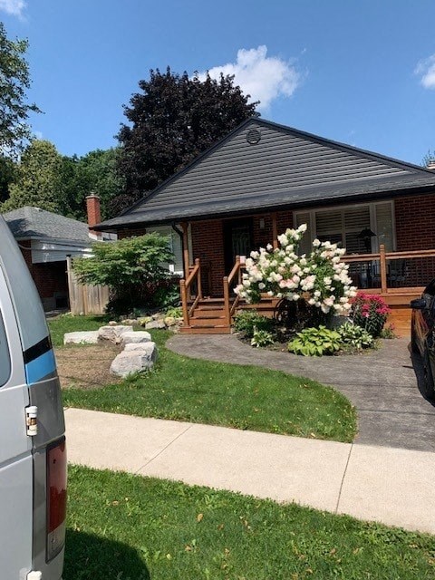 a house with a yard and a sidewalk in front of it