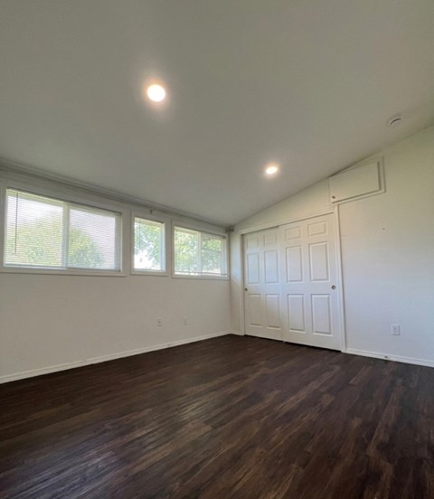 A room with a white door and windows.