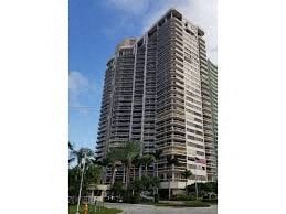 a tall building with palm trees in front of it