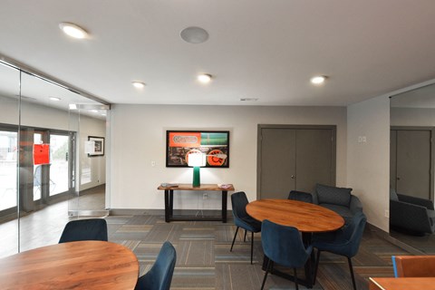 A modern dining area with a wooden table surrounded by chairs.