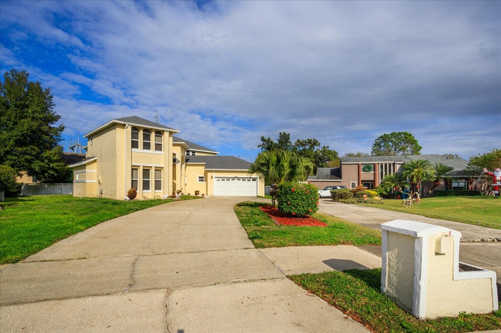 A house with a driveway and a mailbox in front.