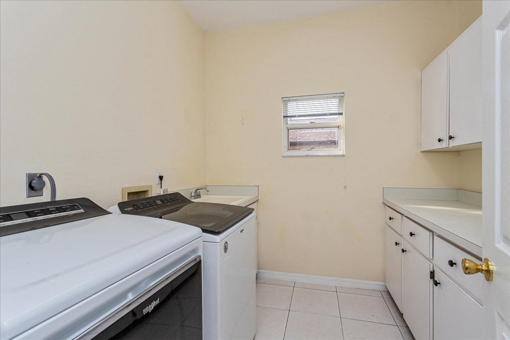 A small kitchen with a washing machine and a fridge.