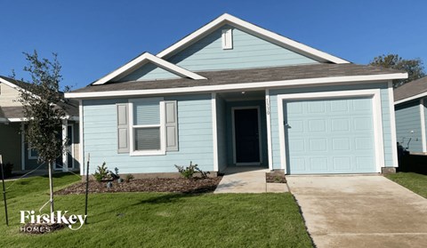 a blue house with a white garage door