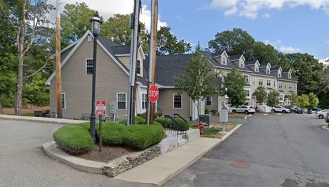 A stop sign is on a pole at a street corner.