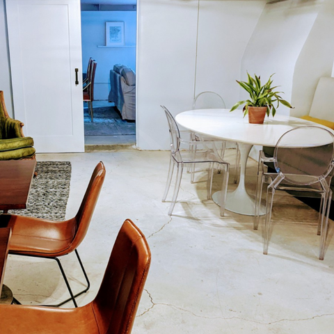 a dining room with a white table and chairs