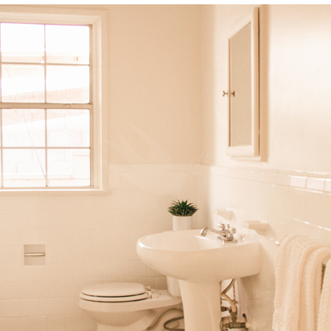 a small bathroom with a sink and a toilet and a window