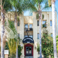 a building with palm trees in front of it