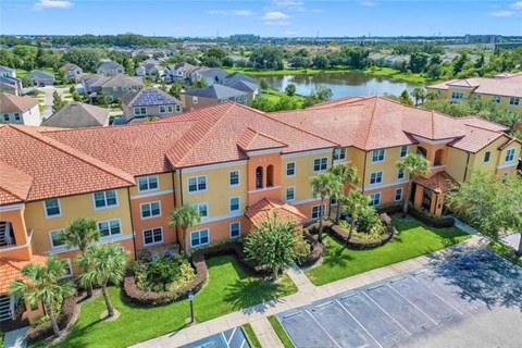 an aerial view of an apartment building with a river in the background