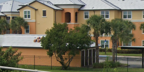 a man laying on the roof of a house