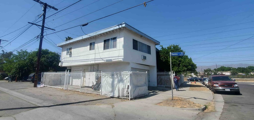 a white house on the corner of a street