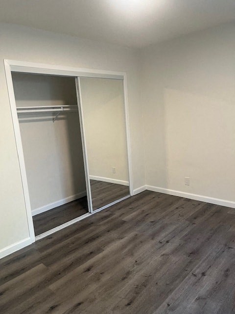 A room with a sliding door and wood flooring.