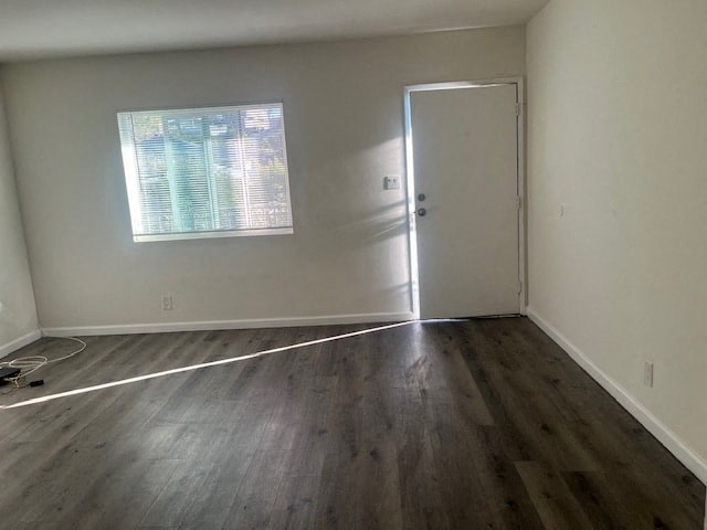 A room with a wooden floor and a white door.