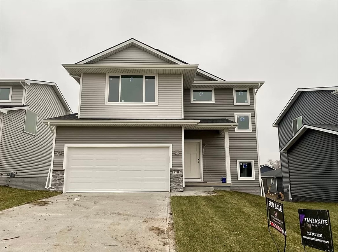 a house with a garage door in front of it