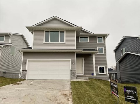 a house with a garage door in front of it