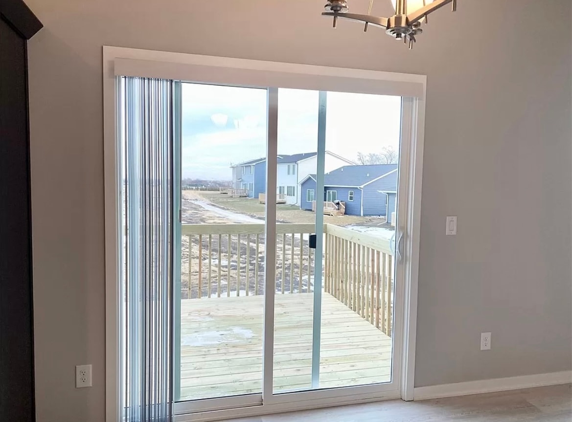 a sliding glass door with a view of a deck