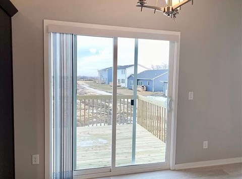 a sliding glass door with a view of a deck