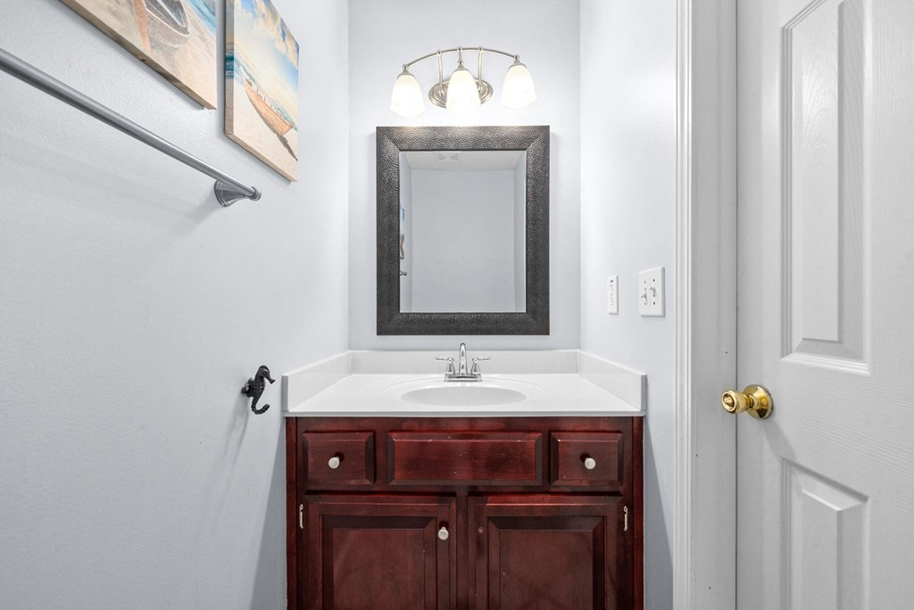 a small bathroom with a sink and a mirror
