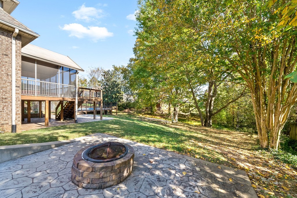 a backyard with a fire pit and a house