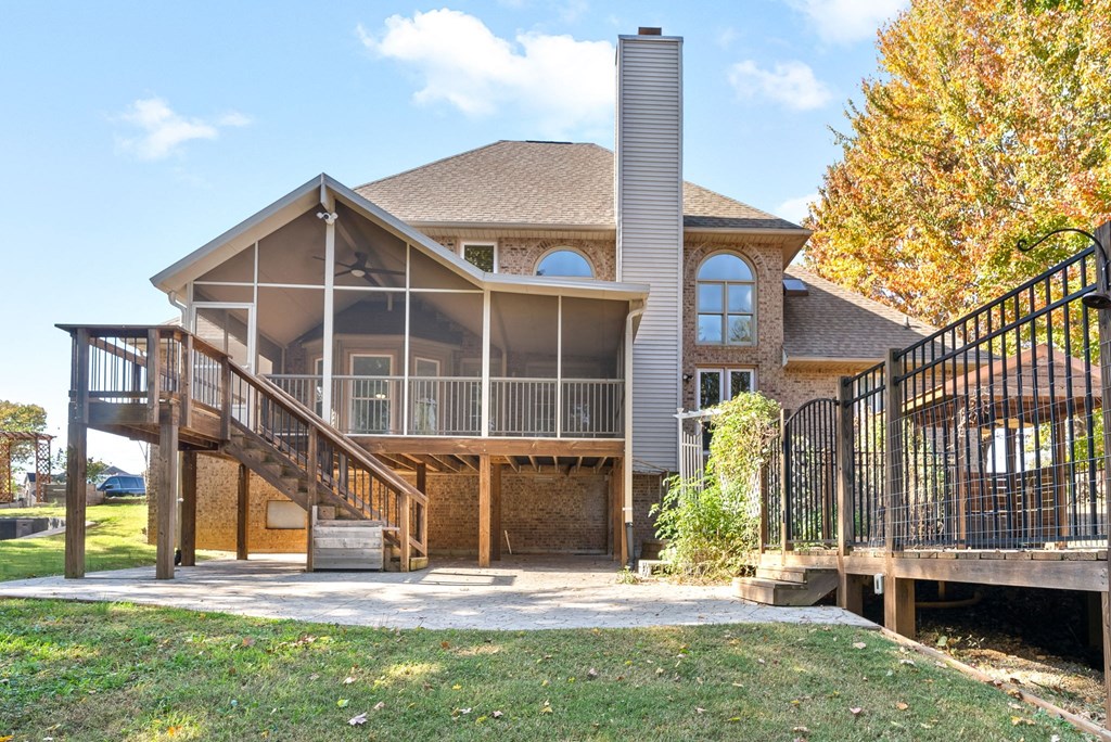 the back of a house with a deck and a staircase