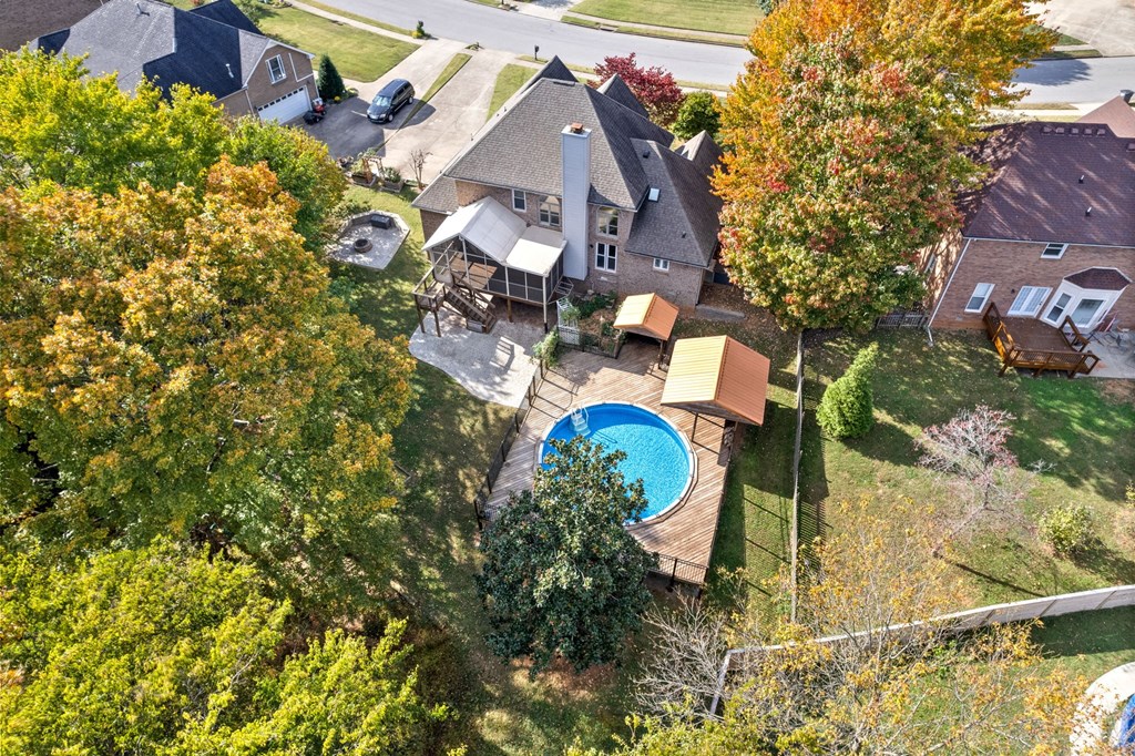 a aerial view of a house with a backyard with a pool and a deck
