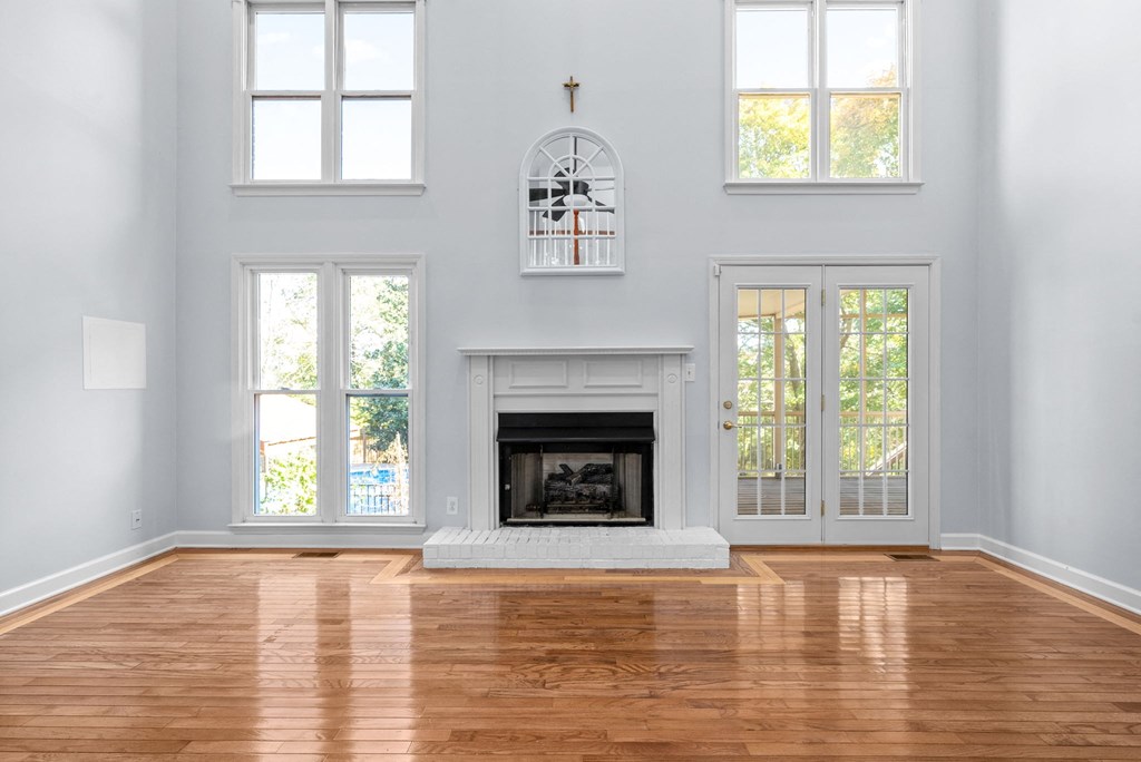 a living room with a fireplace and a hard wood floor