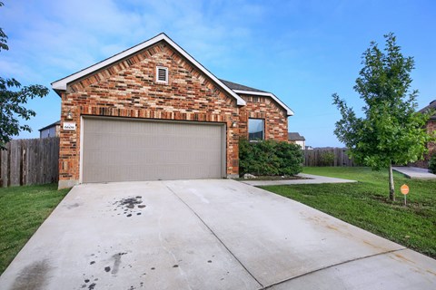 a garage door on a brick house with a driveway