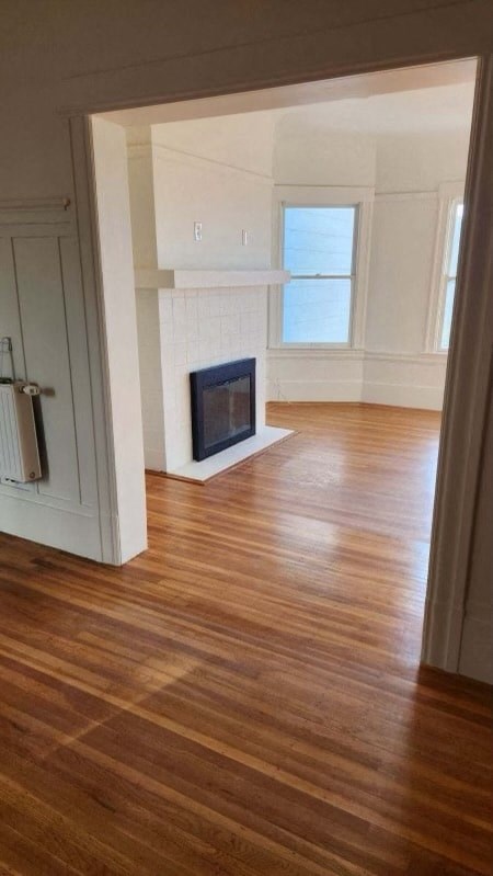 a living room with a fireplace and a wooden floor
