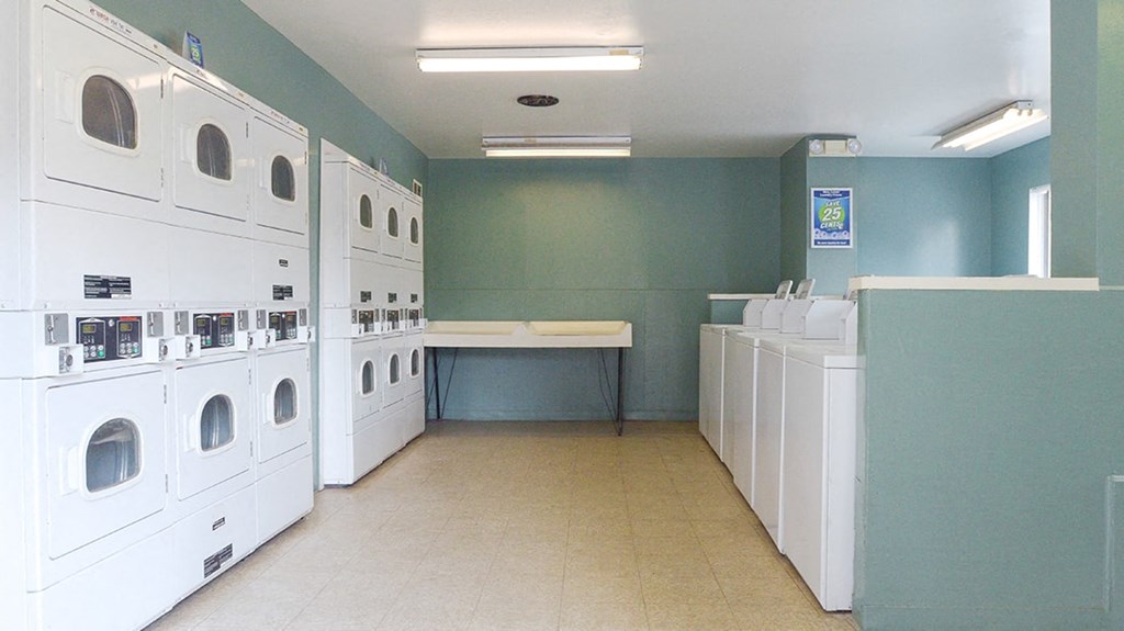 a laundry room filled with washers and dryers