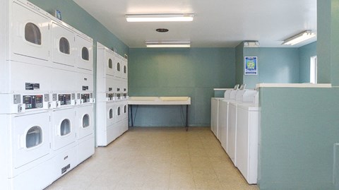 a laundry room filled with washers and dryers
