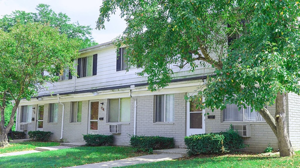 a white house with a tree in front of it
