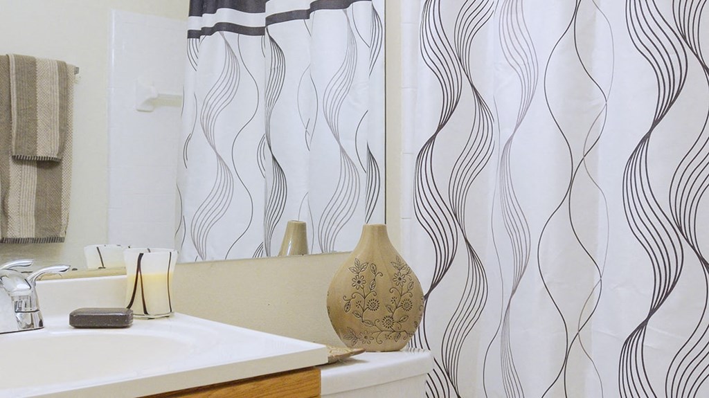 a bathroom with a shower curtain and a sink