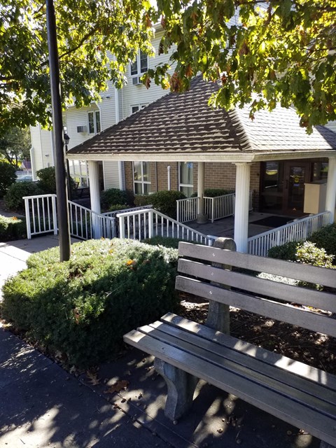 a park bench in front of a gazebo