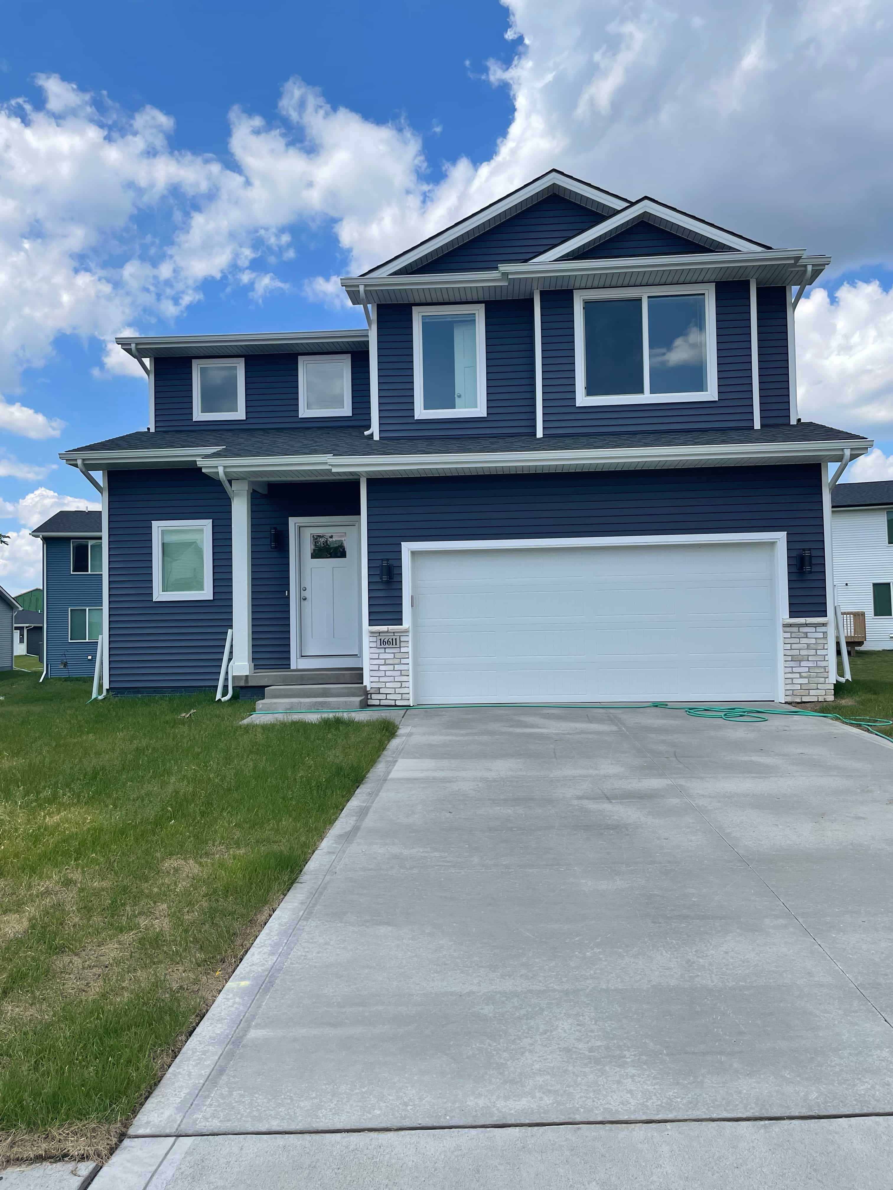 a blue house with a white garage door