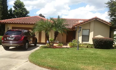 a car parked in a driveway in front of a house