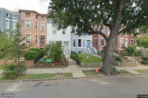 a house with a tree in the front of it