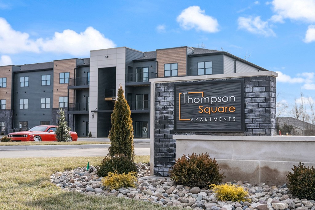 a building with a sign for the homestead square apartments