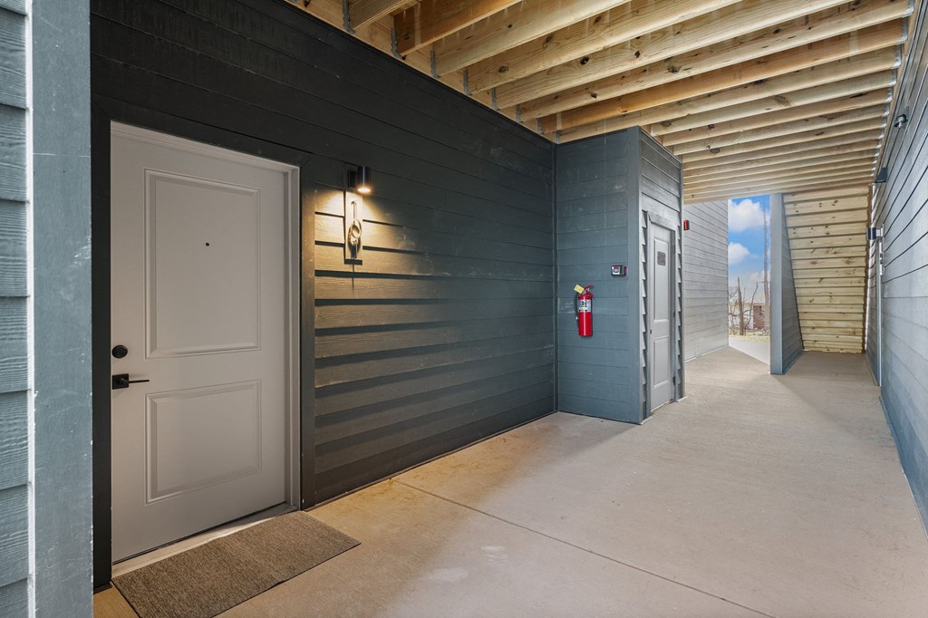 the front door of a building with a white door and blue walls