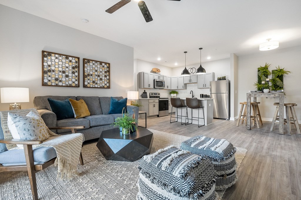 a living room with a couch and a coffee table in front of a kitchen