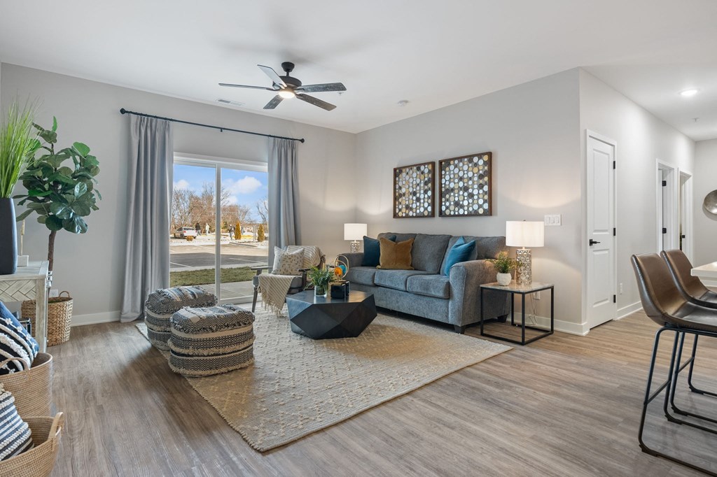 a living room with a couch and a ceiling fan